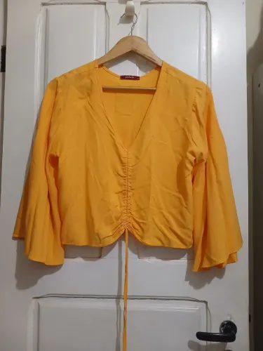 Blusa amarelo da produção