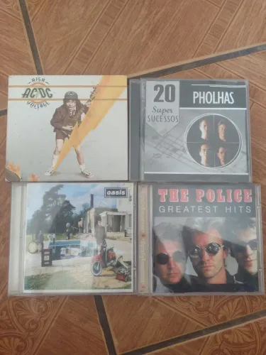 4 Cds originais ac/DC, the police,Os pholhas e Oasis