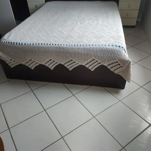 UM CAMA COM COLCHÃO DE CASAL COM CAVETAS NA LATERAL