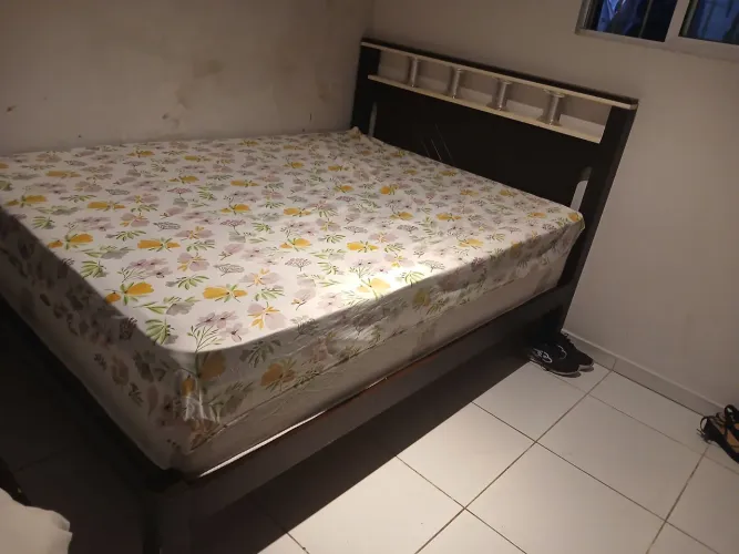 Cama de madeira bem conservada.
