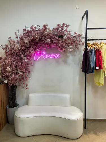 Espaço decorativo Sofa + arranjo de flores + letreiro de led 