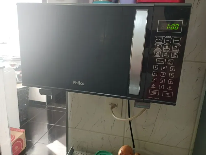 Micro ondas Philco. Funcionando, com ferrugem embaixo do prato e placa de dentro com furo.