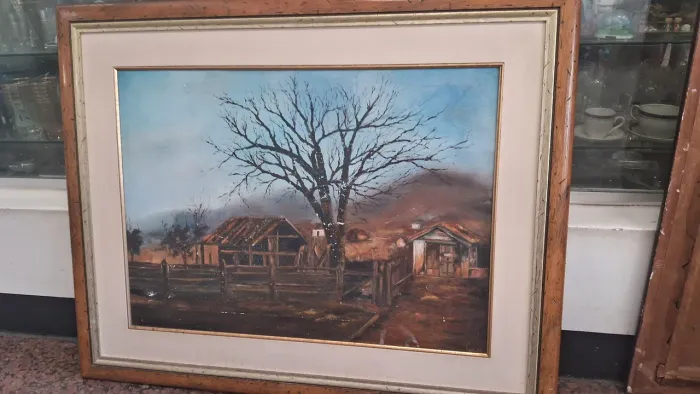 Quadro pintura a óleo sobre tela que retrata uma paisagem rural com construções rústicas