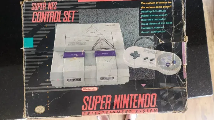 Caixa e Super Nintendo com o Berço