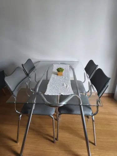 Mesa de vidro com 4 cadeiras.