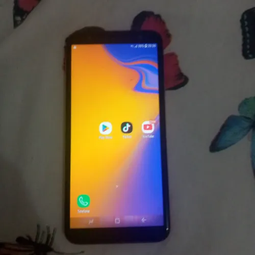 Celular J4 rosa com carregador 