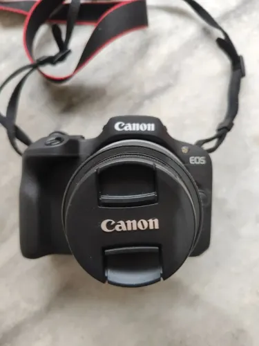 camera canon mirrorfles eosr100 lente 18-45 mm e adaptador EFSXRFS
