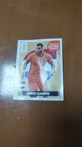 Figurinha Extra Sticker Legend de OURO do jogador Cody Gakpo