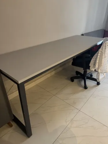 Mesa espaçosa de escritório, cinza, moderna, feita para duas ou até três pessoas.