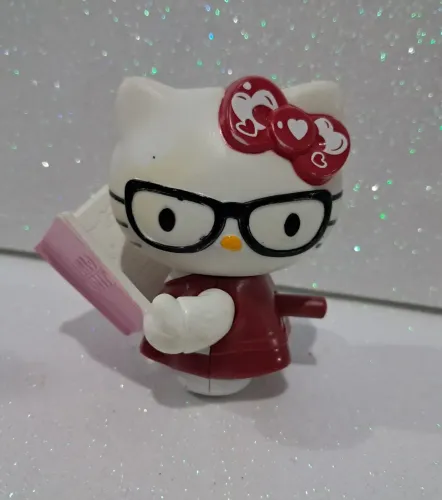 Miniatura colecionável Hello kitty com livro