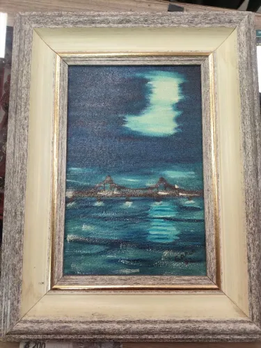 Quadro óleo sobre tela retrata uma ilha anoitecendo autor Carla datado de 1982