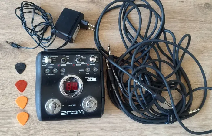 Pedaleira para guitarra Zoom G2 com 2 cabos Santo Angelo fonte e 4 palhetas de brinde.