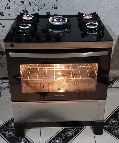 Ótimo fogão Atlas inox com mesa de vidro com tripla chama automático com luminária