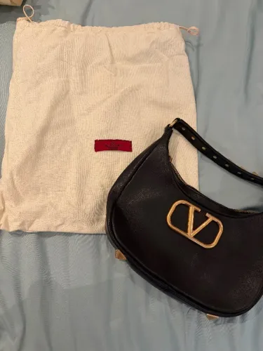 Bolsa Valentino Garavani Preta - Modelo Hobo com Logo V Dourado