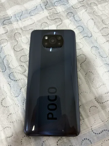 Celular Poco X3 NFC - Caixa original e fonte do carregador juntos.