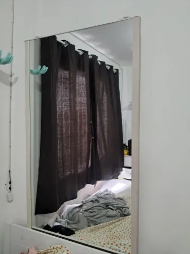 Espelho na moldura de porta de guarda roupa