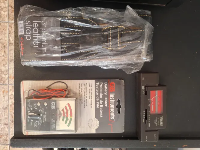 Vendo correia de guitarra em couro + afinador antigo + testador de bateria na embalagem
