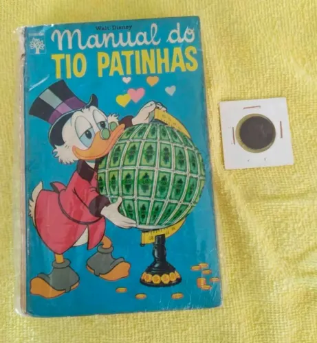 Manual do Tio Patinhas 1972 com a lendária Moeda Pataca Número 1