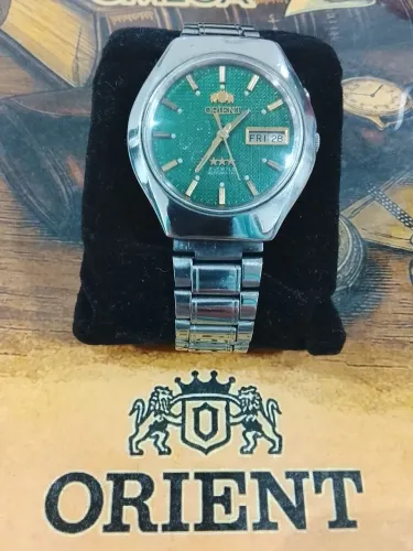 Relógio orient automático fundo verde